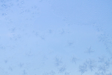 Winter frosty patterns on the frozen ice window