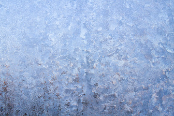 Winter frosty patterns on the frozen ice window