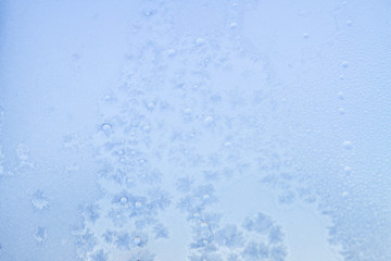 Winter frosty patterns on the frozen ice window