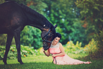 beautiful girl in dress with horse