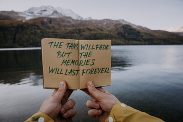 Explorer traveler with his diary on the lakeside