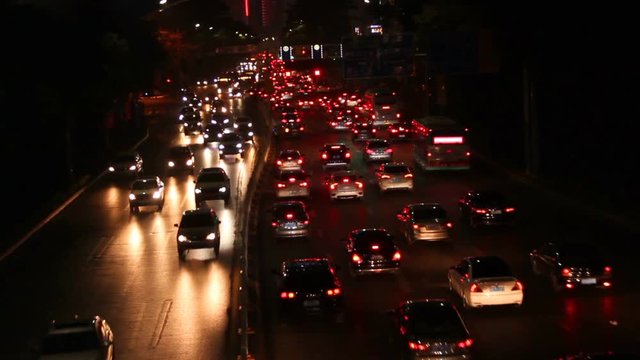 Shekou, Nanshan district Shenzhen, Guangdong province, China; cars and vehicles moving slowly at streets at night; 