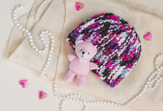 Children's hooked hat handmade. Accessories and details for the newborn photo shoot. Pink glass hearts, white coral and pink cute teddy as a decor