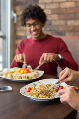 Blurry young handsome man having lunch at a restaurant