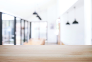 Empty wooden table and blurred background of abstract in front of restaurant or coffee shop for display of product or for montage