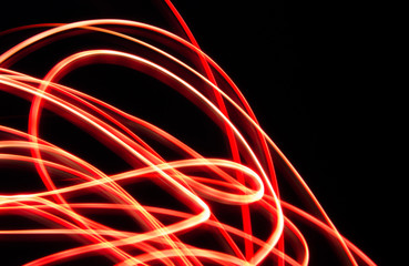 Abstract long exposure red light on black background