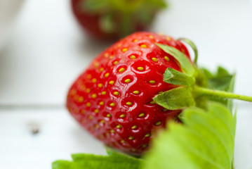 strawberry fruits with jam and whipped cream dessert on white wood table background
