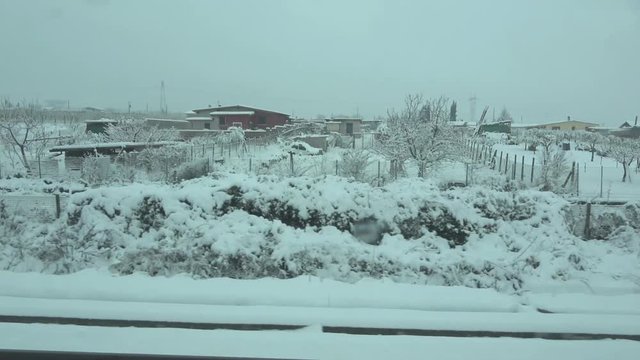 Travel in winter in Italy, background. Train window view. Landscape with snowy fields