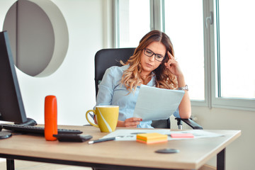 angry businesswoman looking at negative statistic