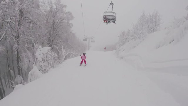 December 2017, Abetone, Italy - A little girl skiing in mountains, gopro footage