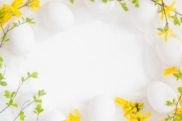 Spring Easter background with white eggs forsythia flowers