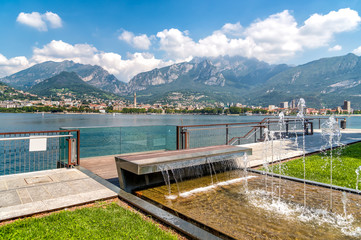 Lakefront of Malgrate located on the shores of Como Lake with view to Lecco city, Italy - obrazy, fototapety, plakaty