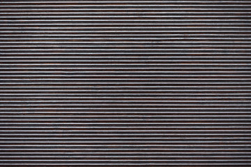 Obraz premium Ribbed surface of dark color with even stripes