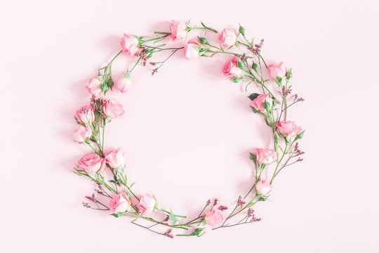 Flowers composition. Wreath made of pink rose flowers on pink background. Flat lay, top view, copy space