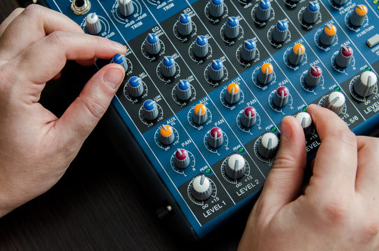 The hands control the musical mixer