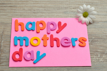 Happy mothers day on a pink note with a white daisy