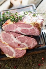 A piece of smoked meat with herbs