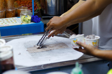 Fototapeta na wymiar making ice cream on cold surface with spatula