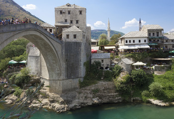 Fototapeta na wymiar View of old Mostar bridge full of people in summer season