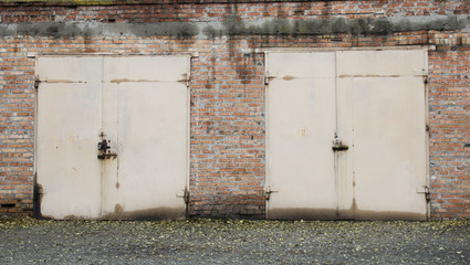 Old abandoned garages with beige metal gates