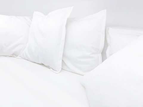 Few White Pillows On Bed. Clear White Bed Linen For Restful Sleep.
