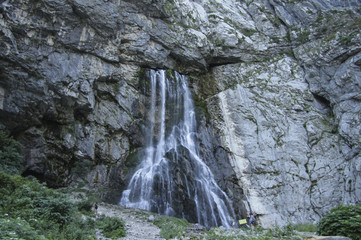 Fototapeta na wymiar Vertical picturesque natural landscape mountain waterfall