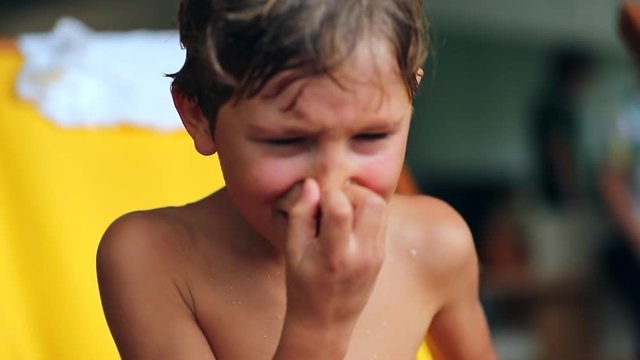 Child crying and sobbing uncontrollably in 120fps slow-motion. Candid authentic clip of young boy weeping with sad unhappy expression
