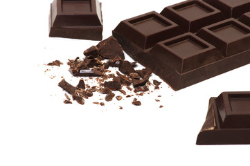Broken chocolate bar isolated on white