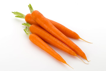 Carrot vegetable with leaves on the wooden background.