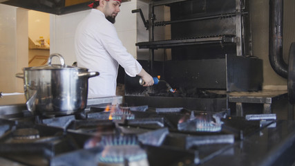 Kindling of charcoal in the barbecue oven using a gas burner slow motion