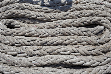 Thick white ropes on a sailing ship.