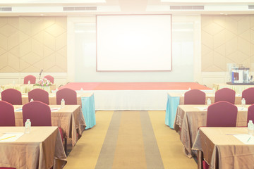 Conference Meeting Room , Row of  Chairs with Stage and Empty Screen for Business Meeting, Conference, Training Course, used as Template of The Elegant Design Office