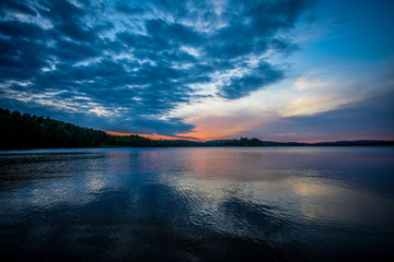 View just before sunrise on a calm lake in northern Ontario, Canada.