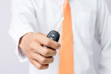 Businessman holding the  car key, isolated background