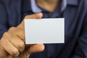 Man's hand showing business card