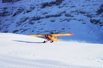 Airplane at Swiss Alpine mountain Mannlichen in winter