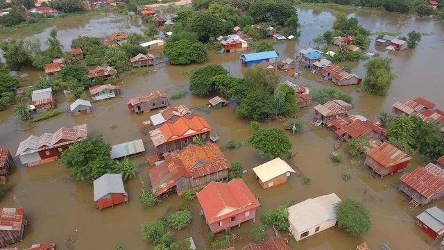 overhead aerial backwards over flooded villages during the monsoon rains