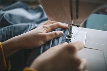  Fashion designer work on the sewing machine.