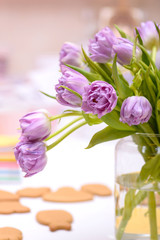 Close-up purple tulips in vase on table