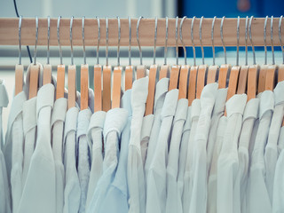 Group of silver-wooden clothes hangers. Fashion concept image