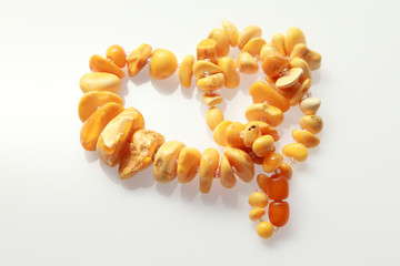 Amber beads / amber beads made from large amber on a white background