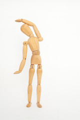 A wooden manicure performs exercises of gymnastics. On a white background.