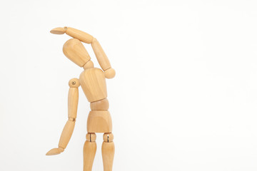 A wooden manicure performs exercises of gymnastics. On a white background.