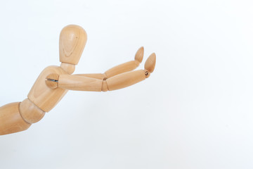 A wooden manicure performs exercises of gymnastics. On a white background.