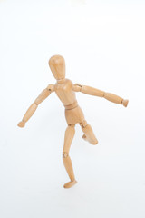 A wooden manicure performs exercises of gymnastics. On a white background.