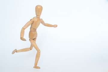 A wooden manicure performs exercises of gymnastics. On a white background.