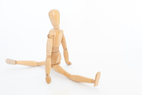 Wooden maniken sits on a string.