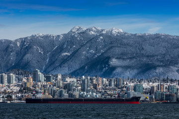 Tanker and Rocky Mountains, North Vancouver, British Colombia, Canada.