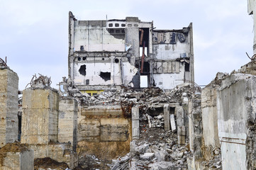 Remains of the destroyed industrial building. The skeleton of a large building of concrete beams