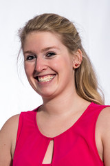 Woman with brouwn hair and red dress posing against white background